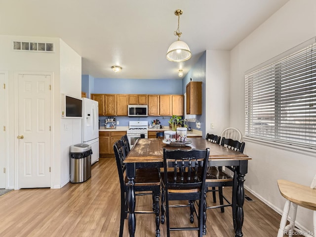 9832 Kenton Cir, Commerce City, CO 80022 - dining room with light wood finished floors and baseboards