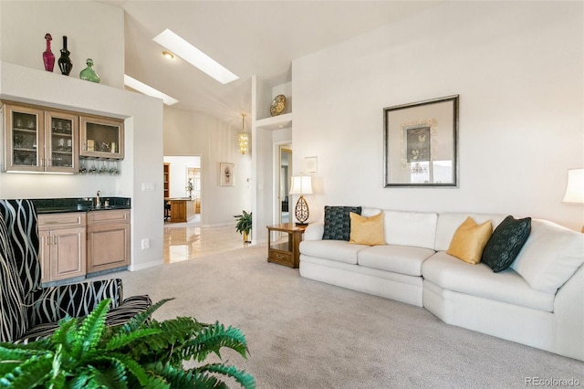 living room with high vaulted ceiling, light colored carpet, and indoor wet bar