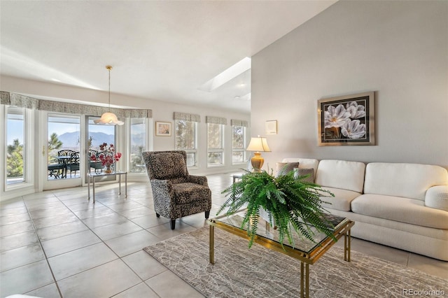 living room featuring light tile patterned flooring and vaulted ceiling