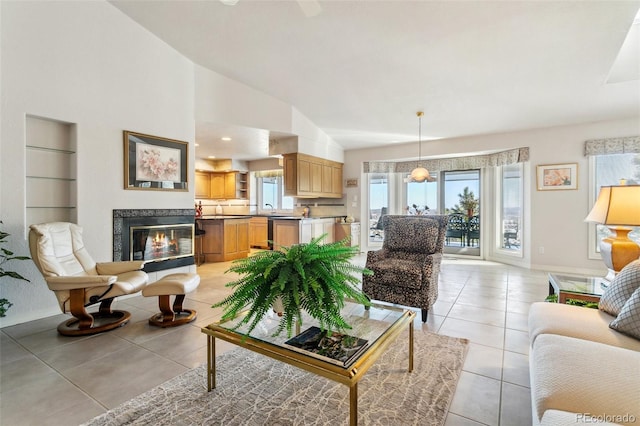 living room featuring high vaulted ceiling, light tile patterned flooring, baseboards, and a fireplace