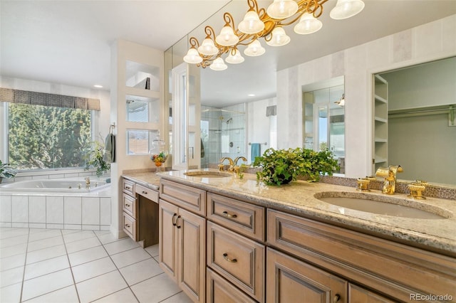 bathroom featuring a chandelier, a stall shower, double vanity, and a sink