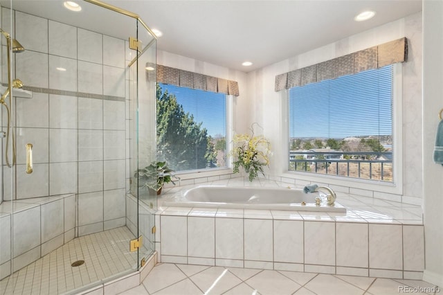 bathroom featuring a shower stall, a bath, and tile patterned flooring