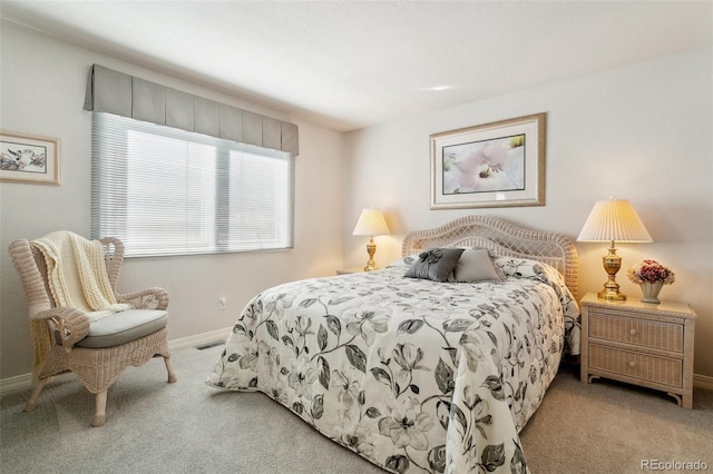 carpeted bedroom featuring baseboards and visible vents