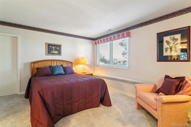 bedroom with carpet, visible vents, baseboards, and a textured ceiling