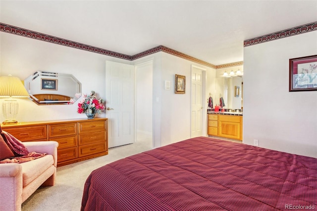 bedroom featuring ensuite bath and light colored carpet