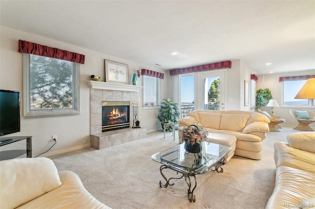 carpeted living room featuring baseboards, a fireplace, plenty of natural light, and recessed lighting