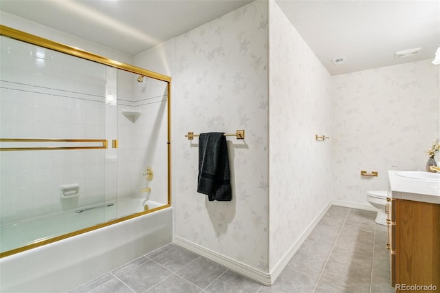 full bath featuring vanity, toilet, bath / shower combo with glass door, tile patterned floors, and wallpapered walls