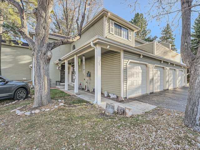 view of property exterior with a porch and a garage