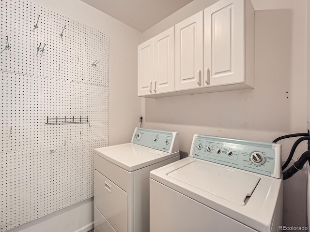 laundry room with cabinets and washer and clothes dryer