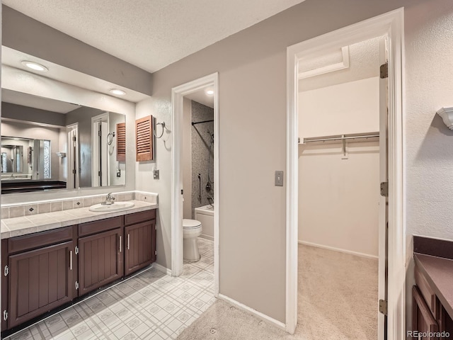 full bathroom featuring vanity, toilet, a textured ceiling, and shower / tub combination