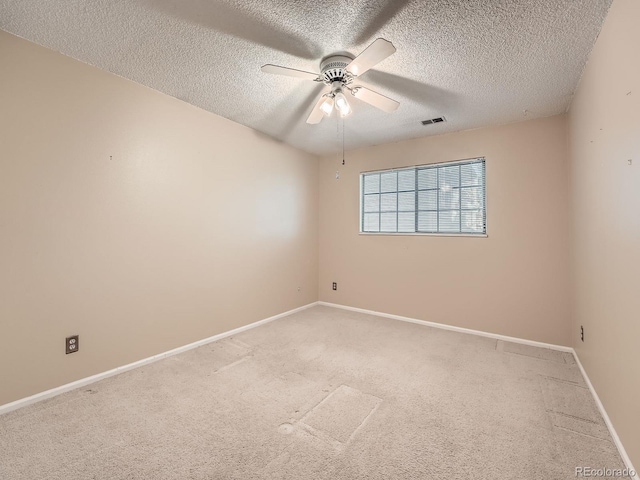 carpeted empty room with a textured ceiling and ceiling fan