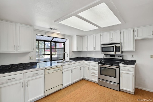 12622 E Warren Dr Unit E, Aurora, CO 80014 - kitchen featuring white cabinetry, appliances with stainless steel finishes, visible vents, and a sink