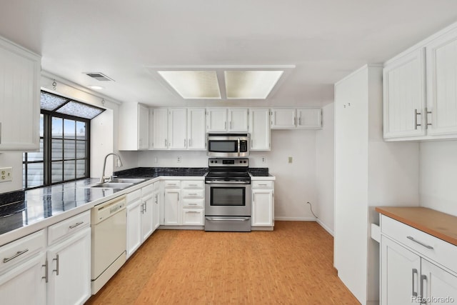 12622 E Warren Dr Unit E, Aurora, CO 80014 - kitchen featuring appliances with stainless steel finishes, a sink, and white cabinetry