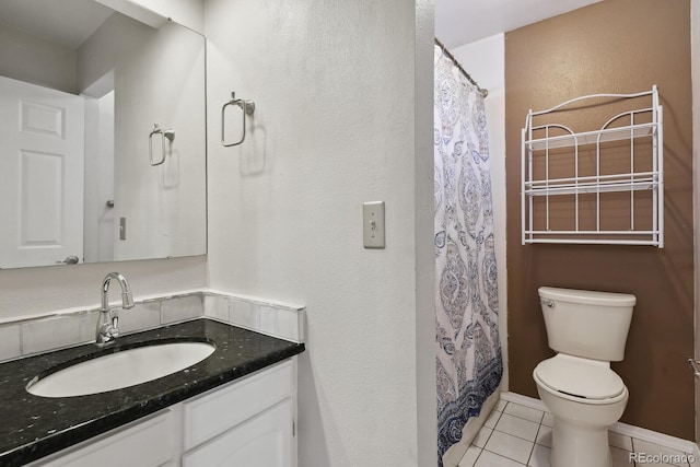 12622 E Warren Dr Unit E, Aurora, CO 80014 - bathroom featuring tile patterned floors, toilet, vanity, baseboards, and curtained shower