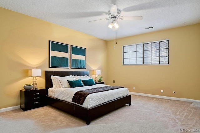 12622 E Warren Dr Unit E, Aurora, CO 80014 - bedroom featuring carpet flooring, baseboards, a textured ceiling, and a ceiling fan