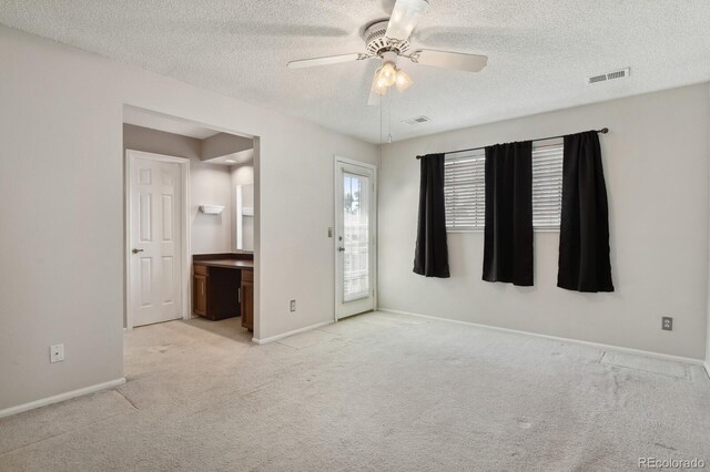 12622 E Warren Dr Unit E, Aurora, CO 80014 - spare room featuring light colored carpet, ceiling fan, a textured ceiling, and baseboards