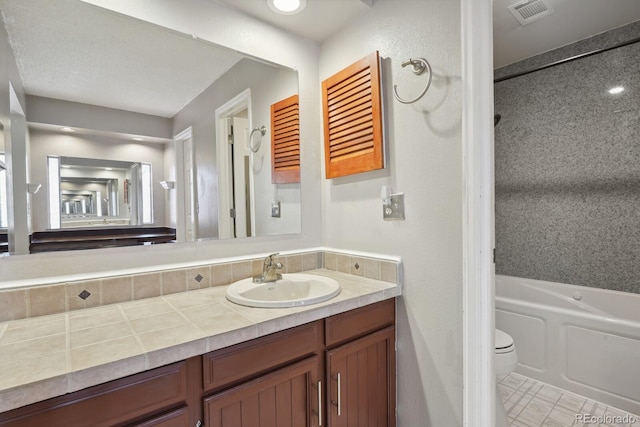 12622 E Warren Dr Unit E, Aurora, CO 80014 - full bath with vanity, toilet, and tile patterned flooring