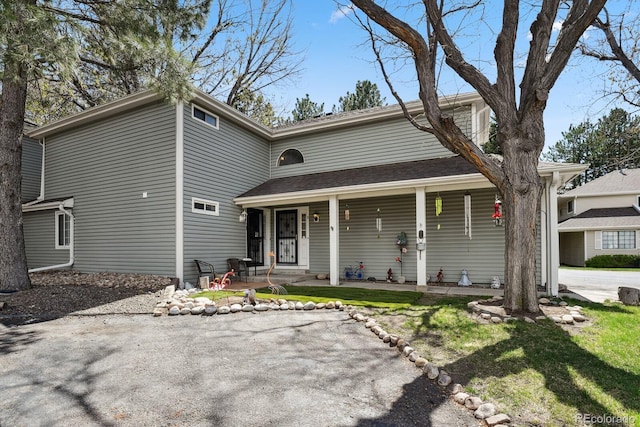 12622 E Warren Dr Unit E, Aurora, CO 80014 - view of front of house featuring covered porch and a front lawn