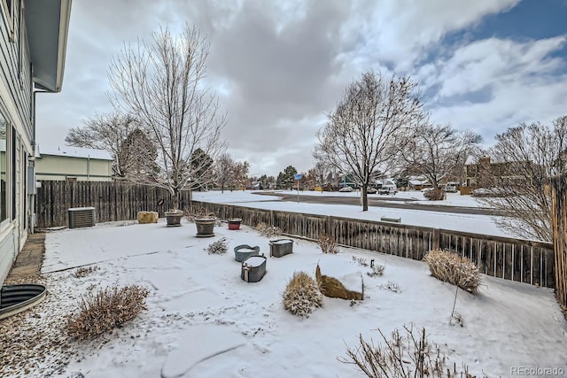 yard layered in snow featuring cooling unit