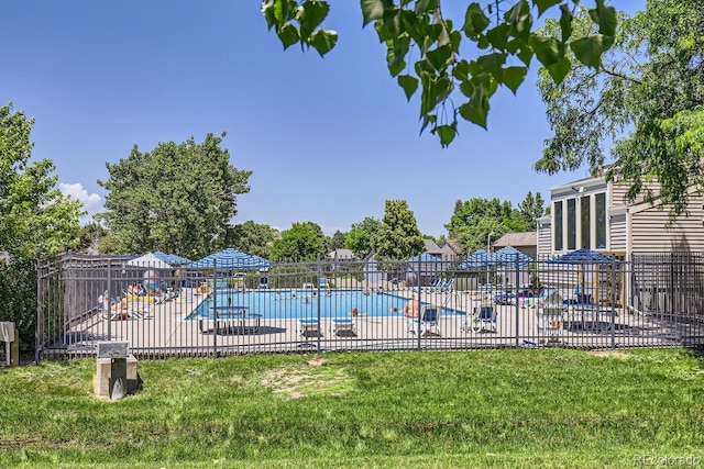 view of pool featuring a yard and a patio area