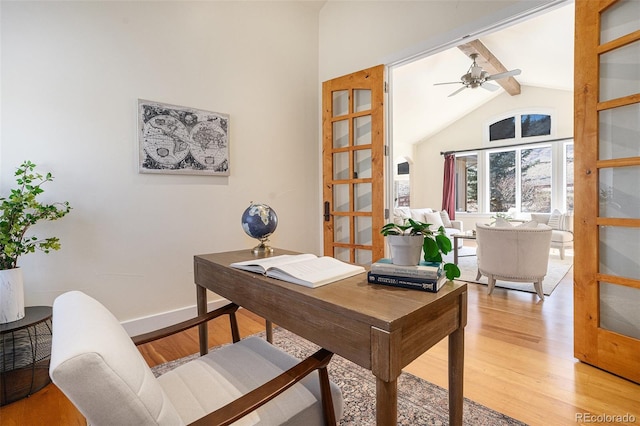 office featuring beam ceiling, light wood-style floors, ceiling fan, high vaulted ceiling, and baseboards