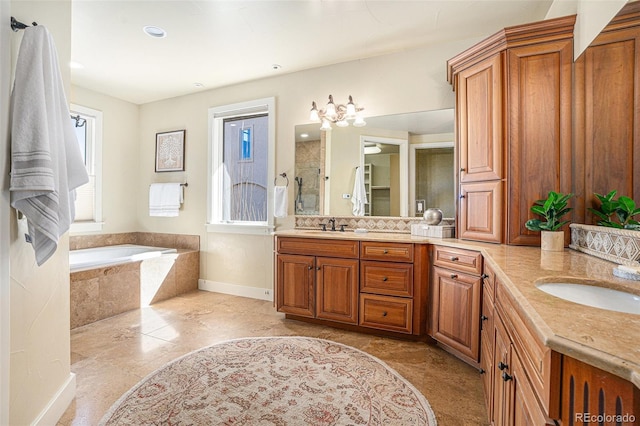 bathroom with plenty of natural light, a sink, and a tile shower