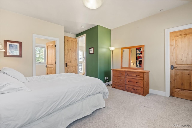 bedroom with carpet floors and baseboards