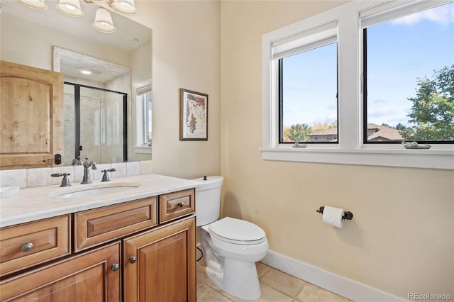 full bathroom with toilet, a stall shower, vanity, tile patterned flooring, and baseboards