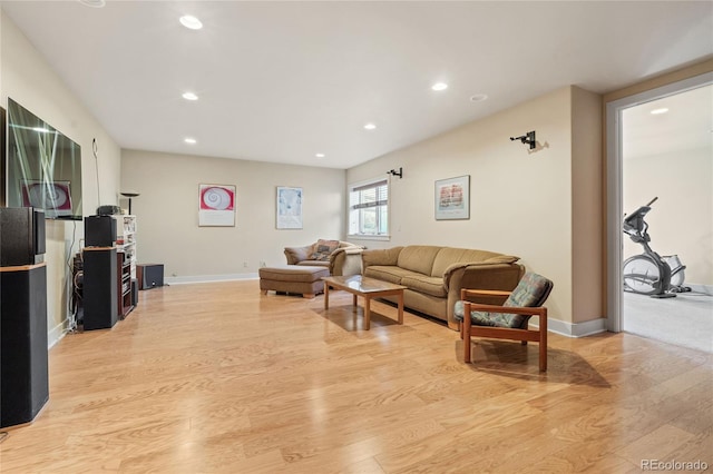 living room with light wood-style floors, baseboards, and recessed lighting