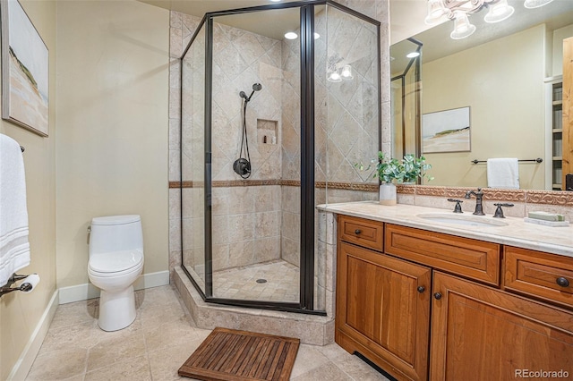 full bath featuring a stall shower, baseboards, vanity, and toilet