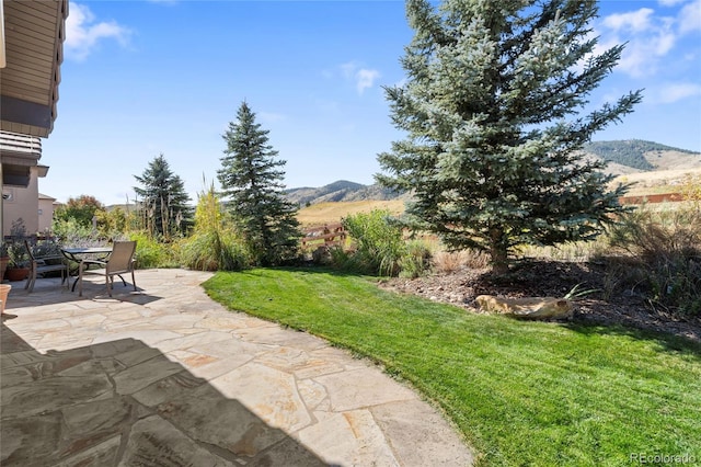 view of patio / terrace with a mountain view and outdoor dining area