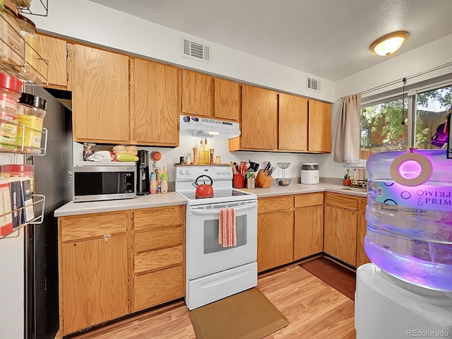 kitchen featuring white electric stove and light hardwood / wood-style floors