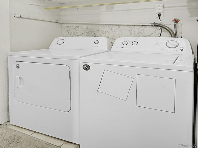 laundry area featuring separate washer and dryer and tile patterned floors