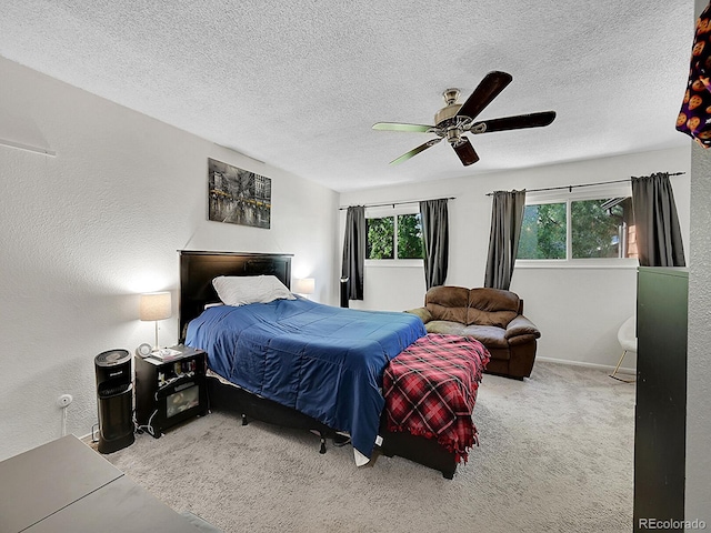 carpeted bedroom with a textured ceiling and ceiling fan