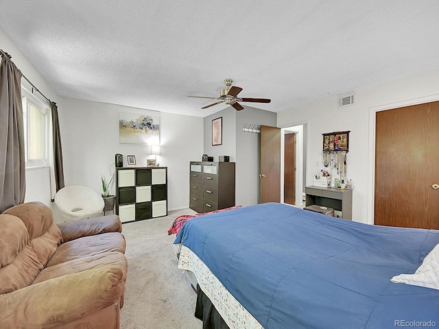 bedroom featuring a textured ceiling, carpet flooring, and ceiling fan