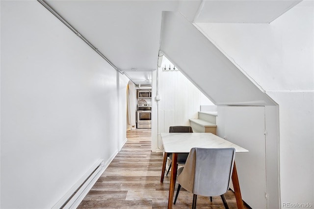 dining area featuring light wood-type flooring and baseboard heating