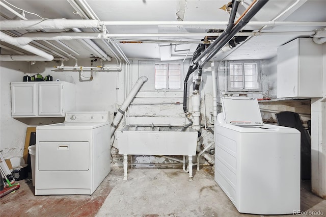 laundry area with cabinets, sink, and washer and dryer