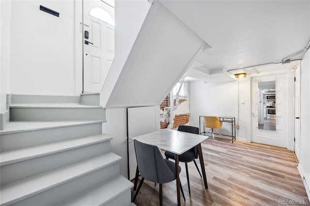 1331 N Ogden St Unit 1, Denver, CO 80218 - dining space featuring light wood-style floors and stairs