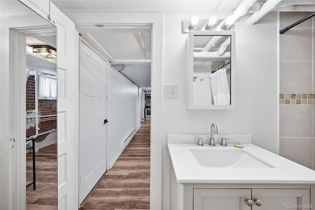 1331 N Ogden St Unit 1, Denver, CO 80218 - bathroom with vanity, wood finished floors, and a shower with curtain