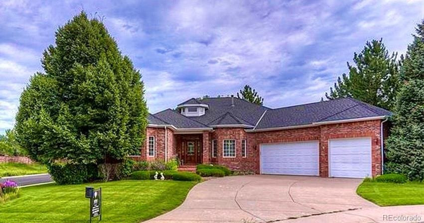 ranch-style house featuring a garage and a front lawn