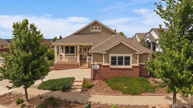 22873 E David Pl, Aurora, CO 80016 - view of front facade featuring a shingled roof, covered porch, and brick siding