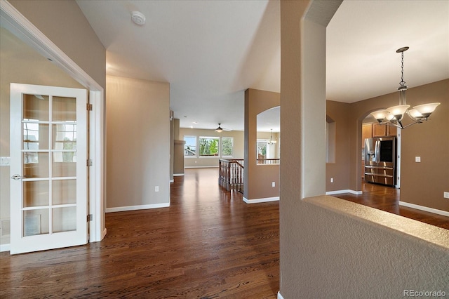 22873 E David Pl, Aurora, CO 80016 - interior space featuring arched walkways, dark wood-style floors, and a chandelier