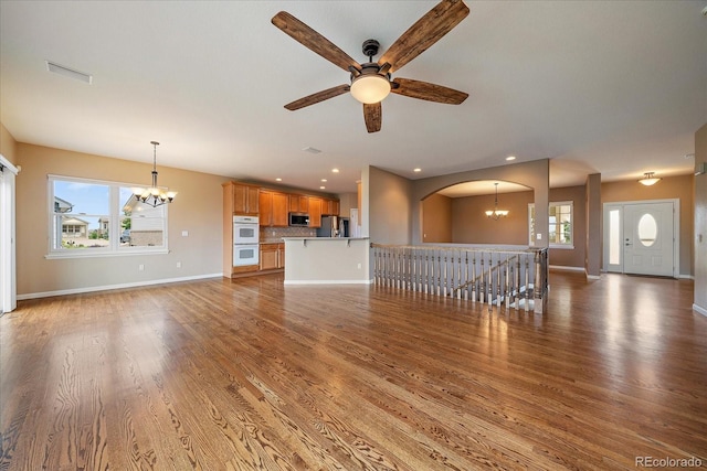 22873 E David Pl, Aurora, CO 80016 - unfurnished living room featuring a chandelier, plenty of natural light, a ceiling fan, light wood-style floors, and recessed lighting