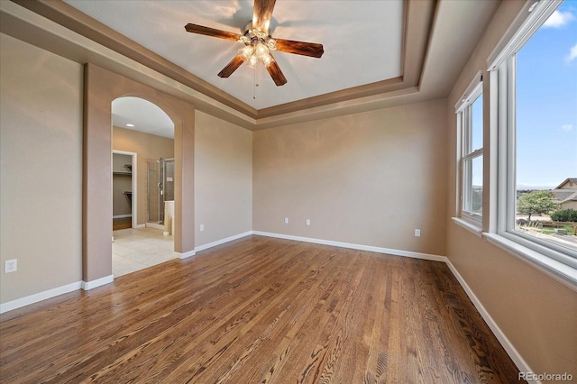 22873 E David Pl, Aurora, CO 80016 - unfurnished room featuring a tray ceiling, ceiling fan, and wood finished floors