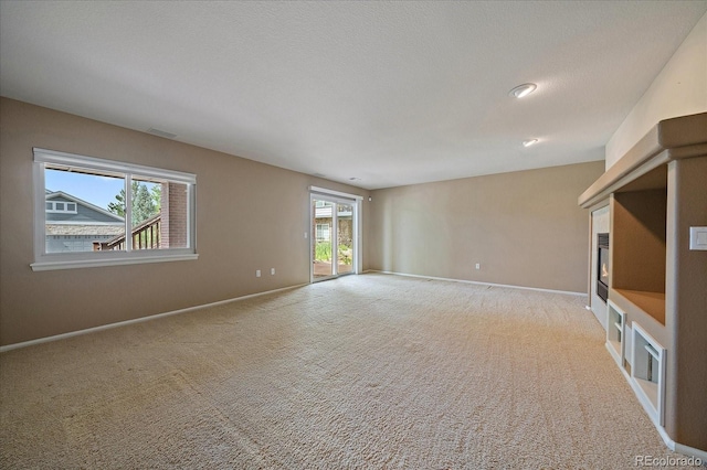 22873 E David Pl, Aurora, CO 80016 - unfurnished living room featuring a glass covered fireplace and carpet