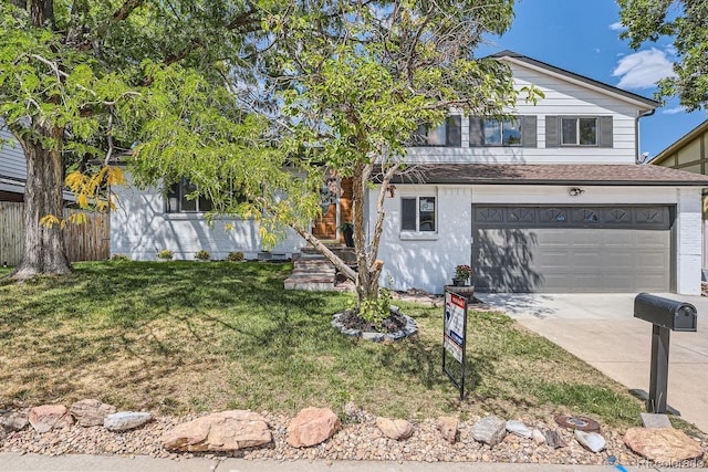 view of front of property featuring a garage and a front yard