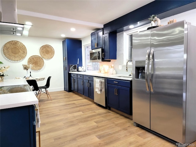 kitchen with stainless steel appliances, extractor fan, sink, blue cabinets, and light wood-type flooring