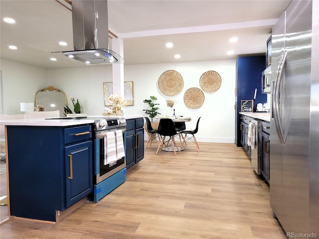 kitchen featuring island exhaust hood, stainless steel appliances, a kitchen island, light wood-type flooring, and blue cabinetry