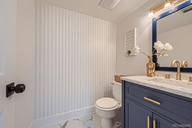 bathroom with toilet and vanity