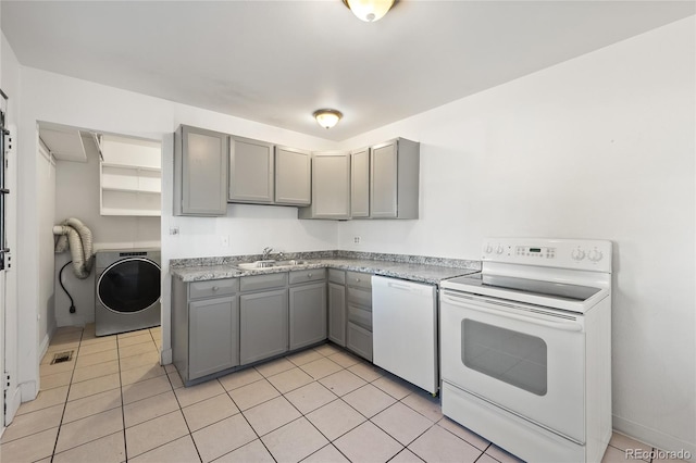 kitchen featuring washer / clothes dryer, sink, light tile patterned floors, gray cabinets, and white appliances